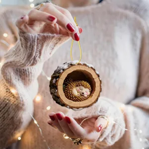 Close-up detail of the cute sleeping hedgehog tree hole Christmas hanging ornament decoration.