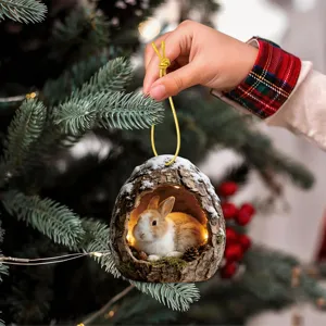 Close-up detail of a cute rabbit tree hole Christmas tree hanging ornament with warm light.