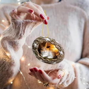 Detailed view of the mini tree hole rabbit hanging ornament with warm LED lights for decor.