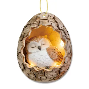 Detailed view of acrylic tree hole sleeping owl hanging ornament with warm glowing lights.