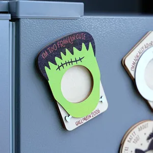 Detailed shot of Halloween wooden magnetic photo frame, Frankenstein monster shape, fridge decor.