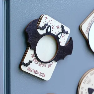 Wooden Halloween magnetic photo frame detail showing bat wings design and engraved holiday text.