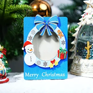 Close-up detail of the wooden Christmas magnetic photo frame with cute snowman and festive decor.
