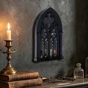 Gothic window mirror detail showing intricate black arch frame and vintage wall decor style.