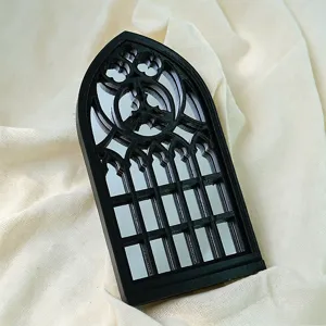 Gothic arch window mirror detail, black decorative tabletop mirror for dark home decor.