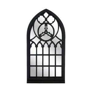 Gothic window mirror detail shot, black arched decorative frame with clear glass panels.