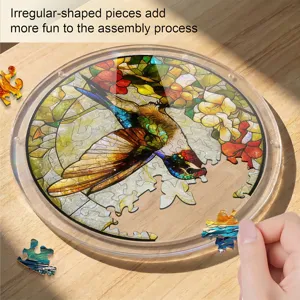 Close-up of stained glass swallow puzzle detail showing irregular pieces on wooden table.