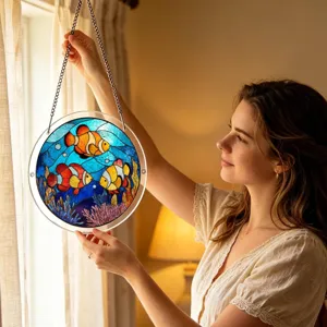 Vue détaillée du attrape-soleil rond en acrylique poisson-clown suspendu à la fenêtre.