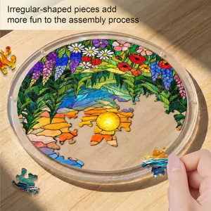 Detail shot of acrylic suncatcher puzzle with stained glass floral and sunset landscape design.