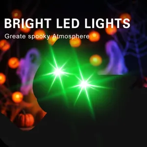 Close-up of glowing green LED eyes on Halloween black cat garden stake yard decor.