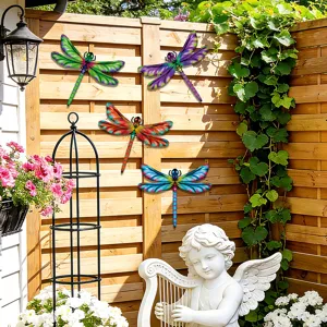Colorful metal dragonfly wall decor closeup showing vibrant garden fence display details.