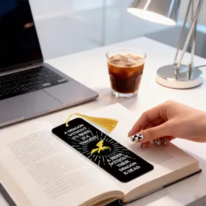 Metal bookmark featuring dragon design and golden tassel, elegant reading accessory.