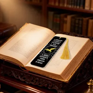 Acrylic dragon bookmark with tassel detail, placed on an open book in a library study setting.