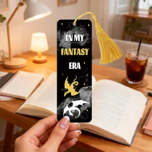 Detailed view of black acrylic bookmark featuring gold tassel and fantasy dragon design for readers.