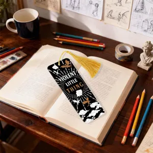 Acrylic tassel bookmark with black gold design, elegant reading accessory for books and study.