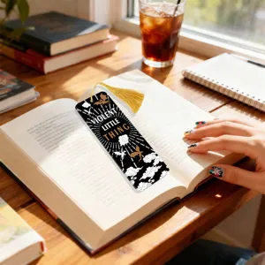 Creative transparent acrylic bookmark with gold tassel and fantasy dragon design for readers.