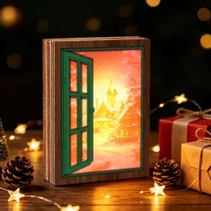 Christmas wooden illuminated window ornament detail view with warm winter snow scene light.