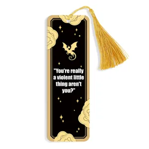 Black gold tassel bookmark featuring dragon pattern and inspiring quote for book lovers.