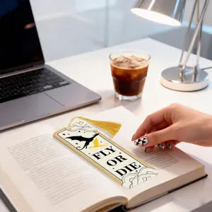 Detailed view of a creative acrylic bookmark showcasing dragon pattern and yellow tassel.