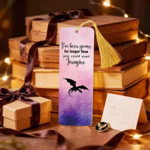 Detailed view of creative translucent acrylic bookmark with golden tassel and dragon design.