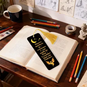 Black acrylic bookmark with gold tassel and quote design for reading lovers and bookish gifts.