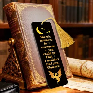 Close-up detail of a black and gold bookmark featuring a fantasy quote and elegant tassel.