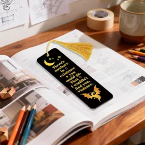 Acrylic bookmark with golden tassel featuring a quote design, perfect for reading lovers.