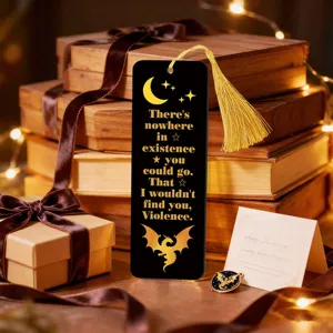 Detailed shot of a black acrylic bookmark with gold foil quote, star design and yellow tassel.