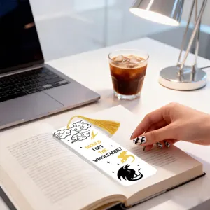 Detailed view of creative dragon quote bookmark with tassel, stylish reading accessory for book lovers.