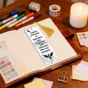 Acrylic translucent bookmark with golden tassel and literary quote design for book lovers detail.