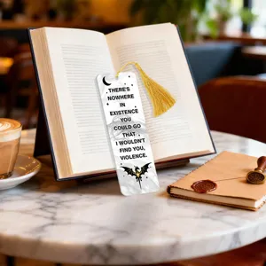 Acrylic bookmark with dragon design, quote, and golden tassel for book lovers and reading.