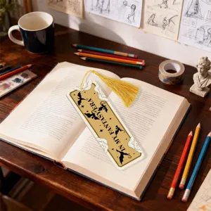 Acrylic bookmark detail scene with tassel and fantasy dragon pattern on reading book desk.