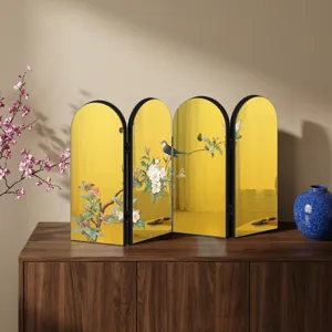 Close-up detail of Chinese style desktop folding screen ornament with golden mirror and floral art.