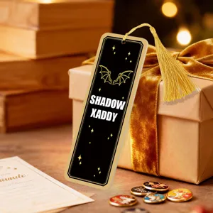 Creative acrylic bookmark with gold tassel, black and gold bat wings design, perfect for reading.