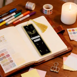 A stylish acrylic bookmark with gold tassel, featuring bat wings and dark gothic design detail.