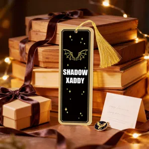 Detailed view of the acrylic translucent bookmark with golden tassel and warm book background.