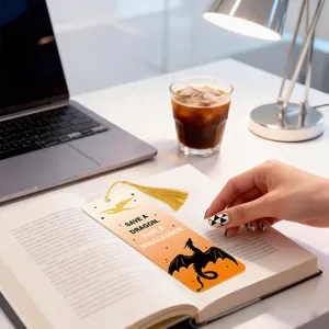 Translucent acrylic bookmark detail featuring dragon silhouette and tassel on desk view.