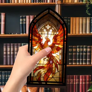 Dettaglio del fermalibri fenice in vetrate, inserto fantasy luminoso per libreria.