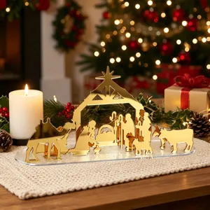 Détails de la crèche de Noël en acrylique miroir doré pour une belle décoration de table de fête.