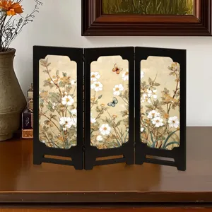 Detailed close-up of vintage wooden folding screen ornament, antique floral butterfly decor.