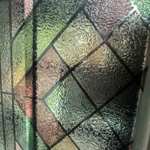 Close-up detail of 3D stained glass window film, geometric diamond pattern, frosted texture.