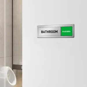 Closeup of a metal sliding door sign for bathrooms, showing available status clearly.