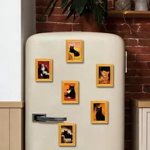 Vintage wooden picture frame fridge magnets featuring funny cat portraits, kitchen decor detail.