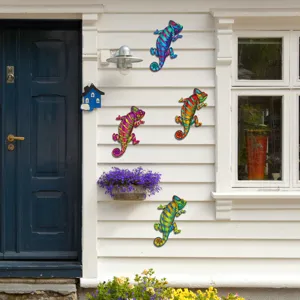 Colorful metal chameleon wall hanging scene detail, vibrant iron garden outdoor decoration display.