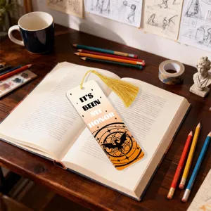 Creative acrylic bookmark with golden tassel and fantasy dragon design for reading.