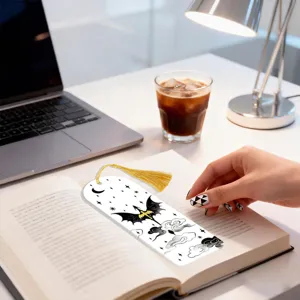Creative acrylic bookmark with golden tassel and fantasy dragon pattern for reading.