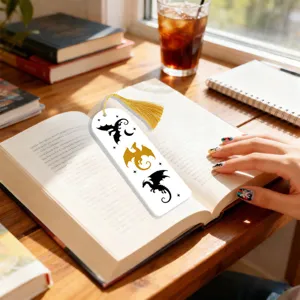 Elegant white dragon bookmark with gold tassel, perfect reading accessory for book lovers.