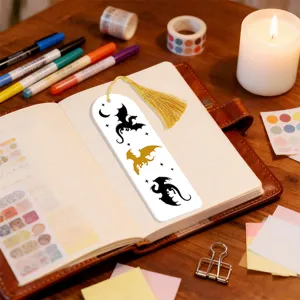 Creative dragon silhouette bookmark with golden tassel, elegant stationery desk setup detail.