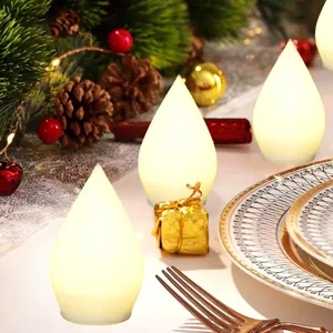 Dettaglio luce LED goccia Natale, accento decoro tavola festiva, atmosfera calda luminosa.