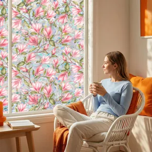 Detailed view of pink magnolia flower window privacy film applied on glass in living room.
